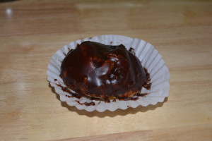 Large cream puff covered in chocolate.